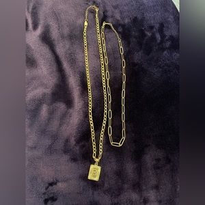 Two gold chain necklaces. One with a charm the Letter “P”